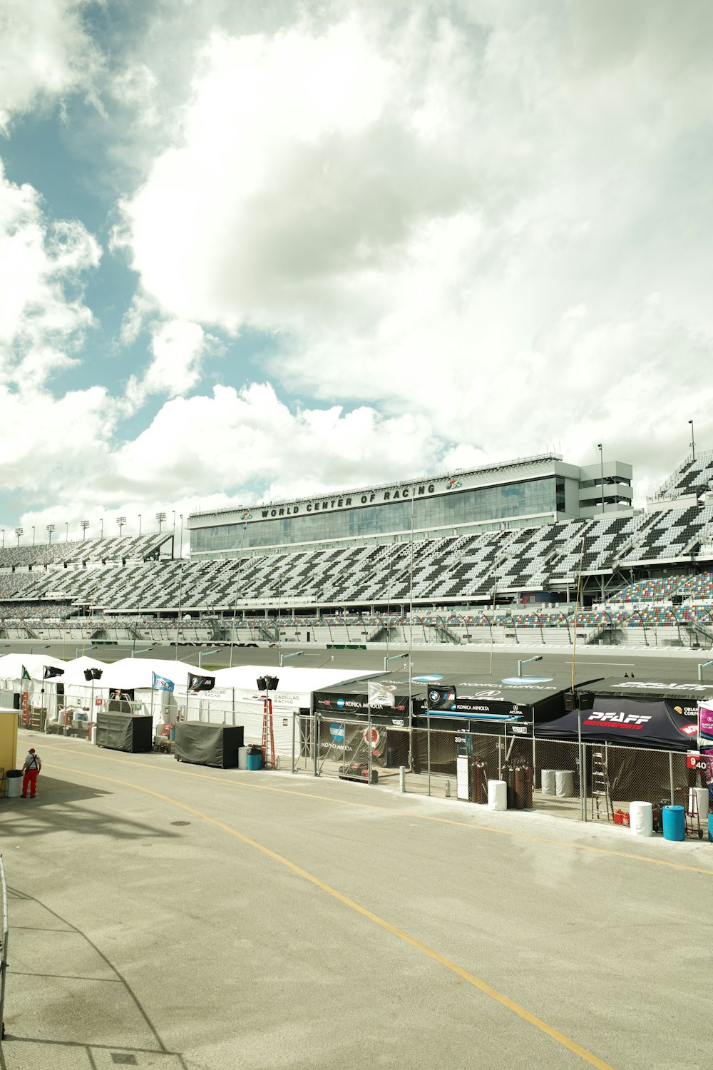 an empty parking lot at a stadium with a sky background