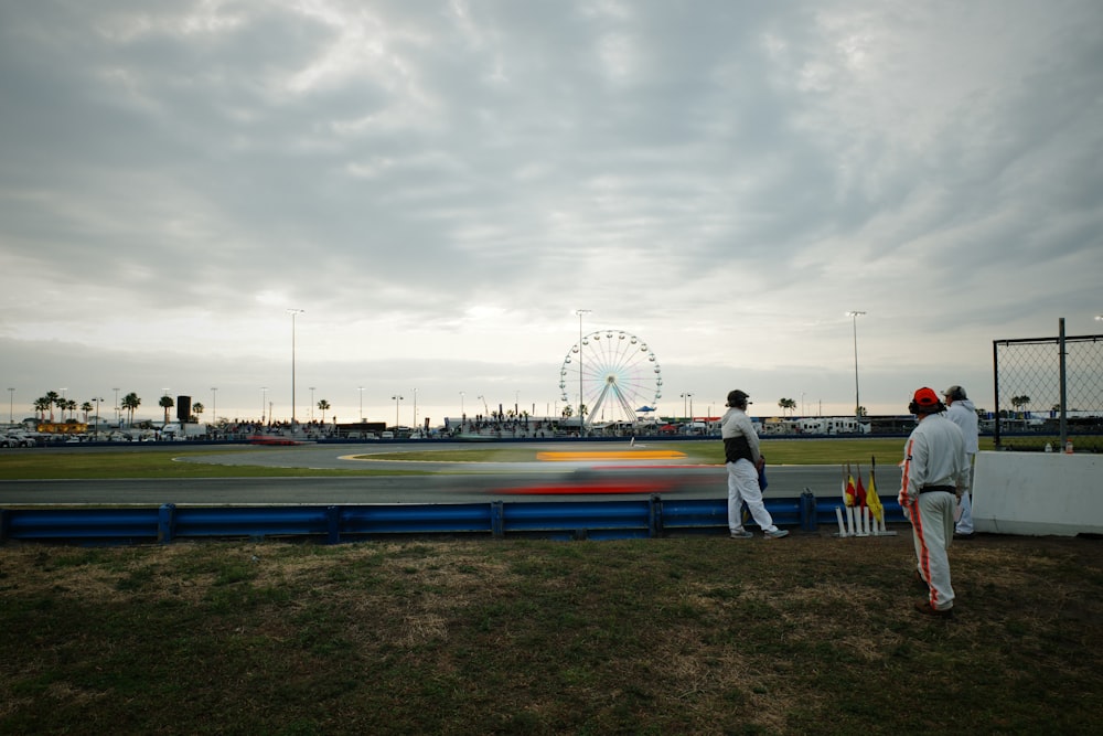 a couple of men standing next to each other on a field