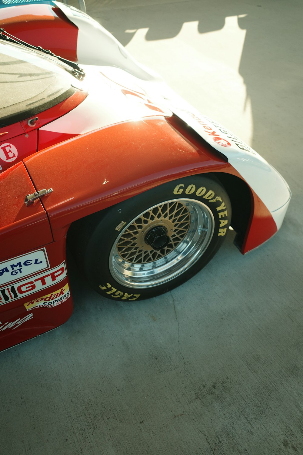 a red race car parked on the side of the road