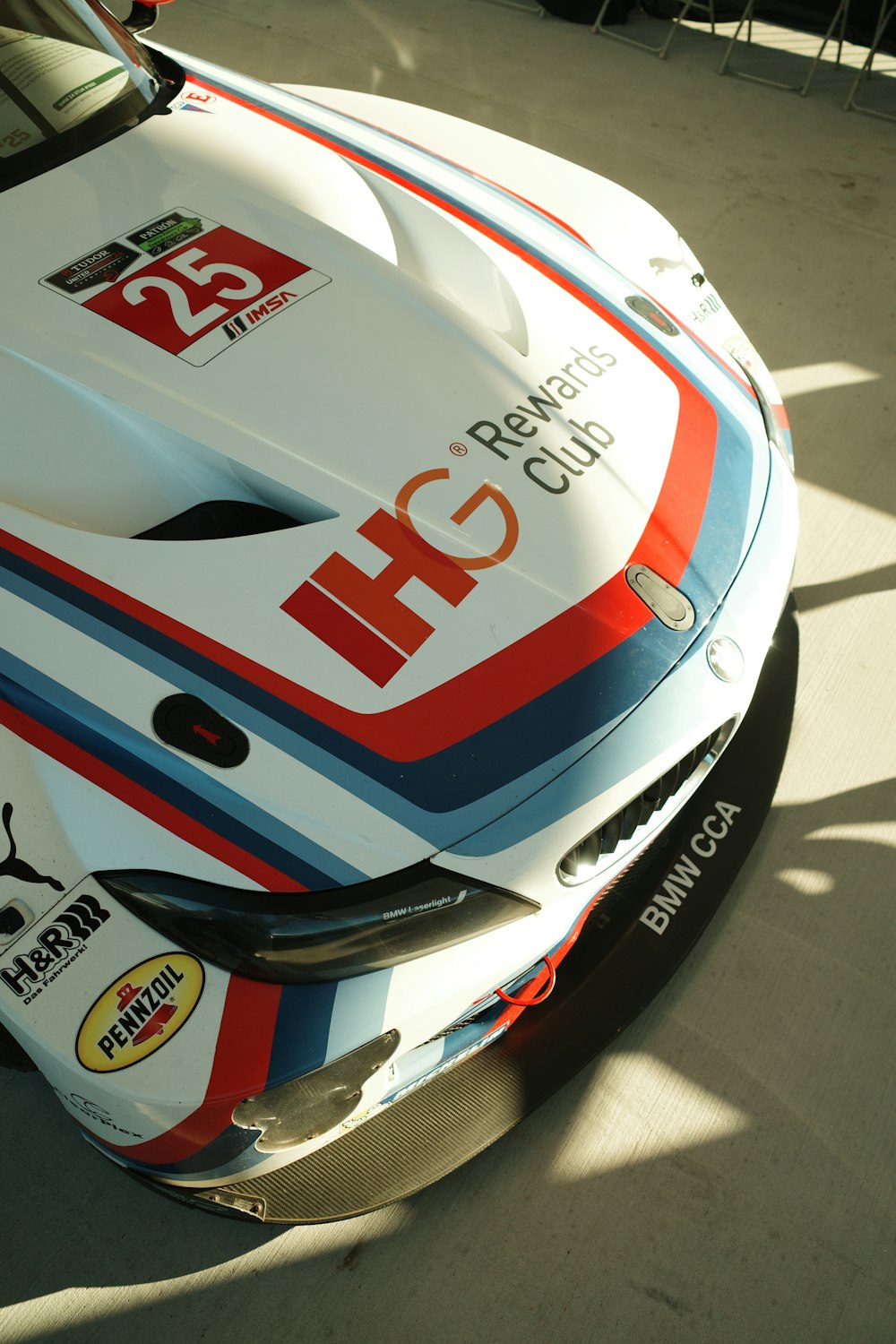 a bmw race car parked in a garage