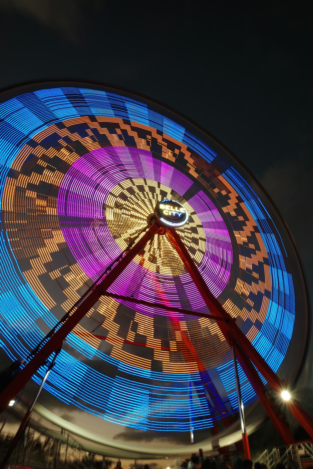 a colorful ferris wheel at a carnival at night