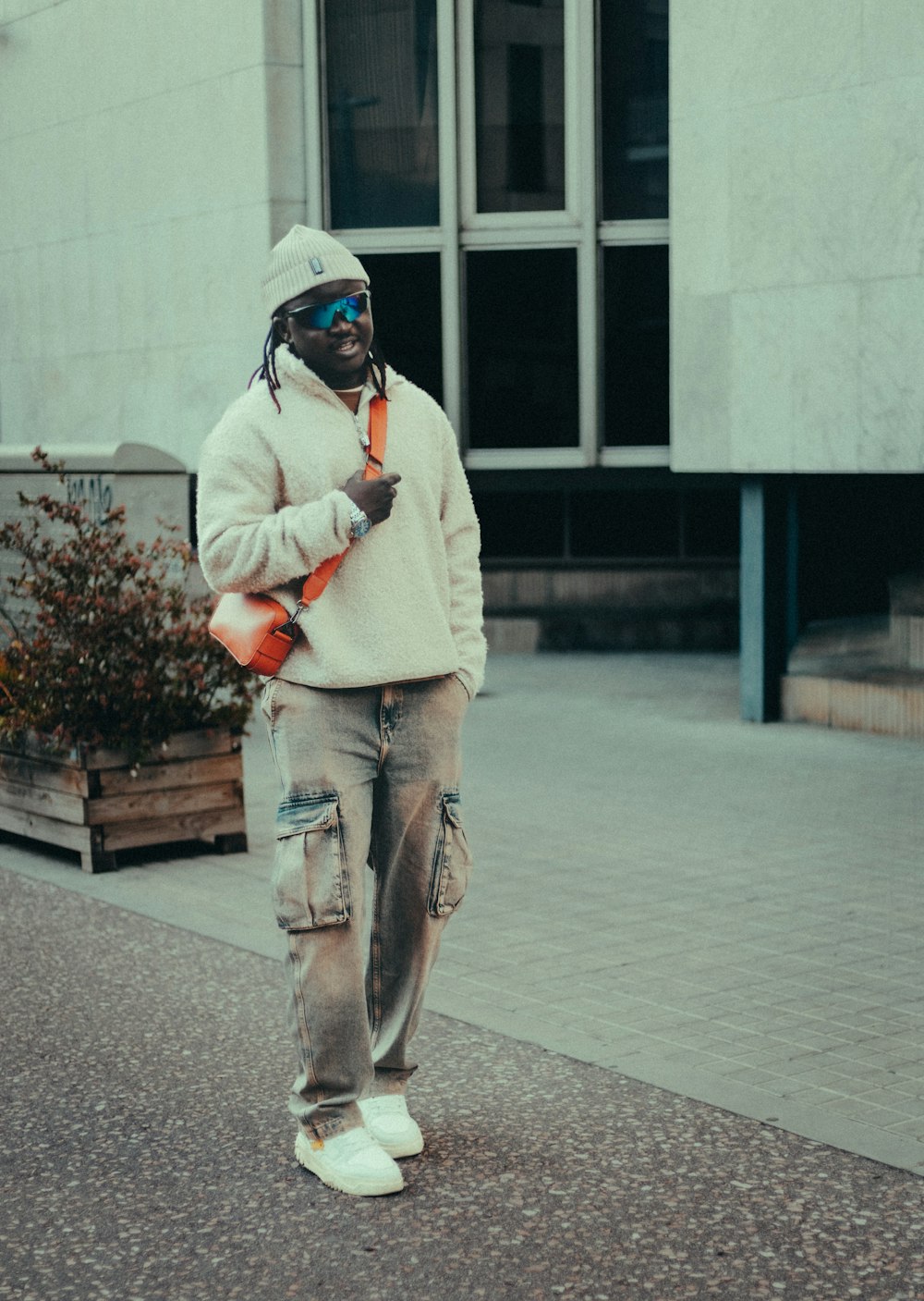 a man walking down a street with a cell phone in his hand