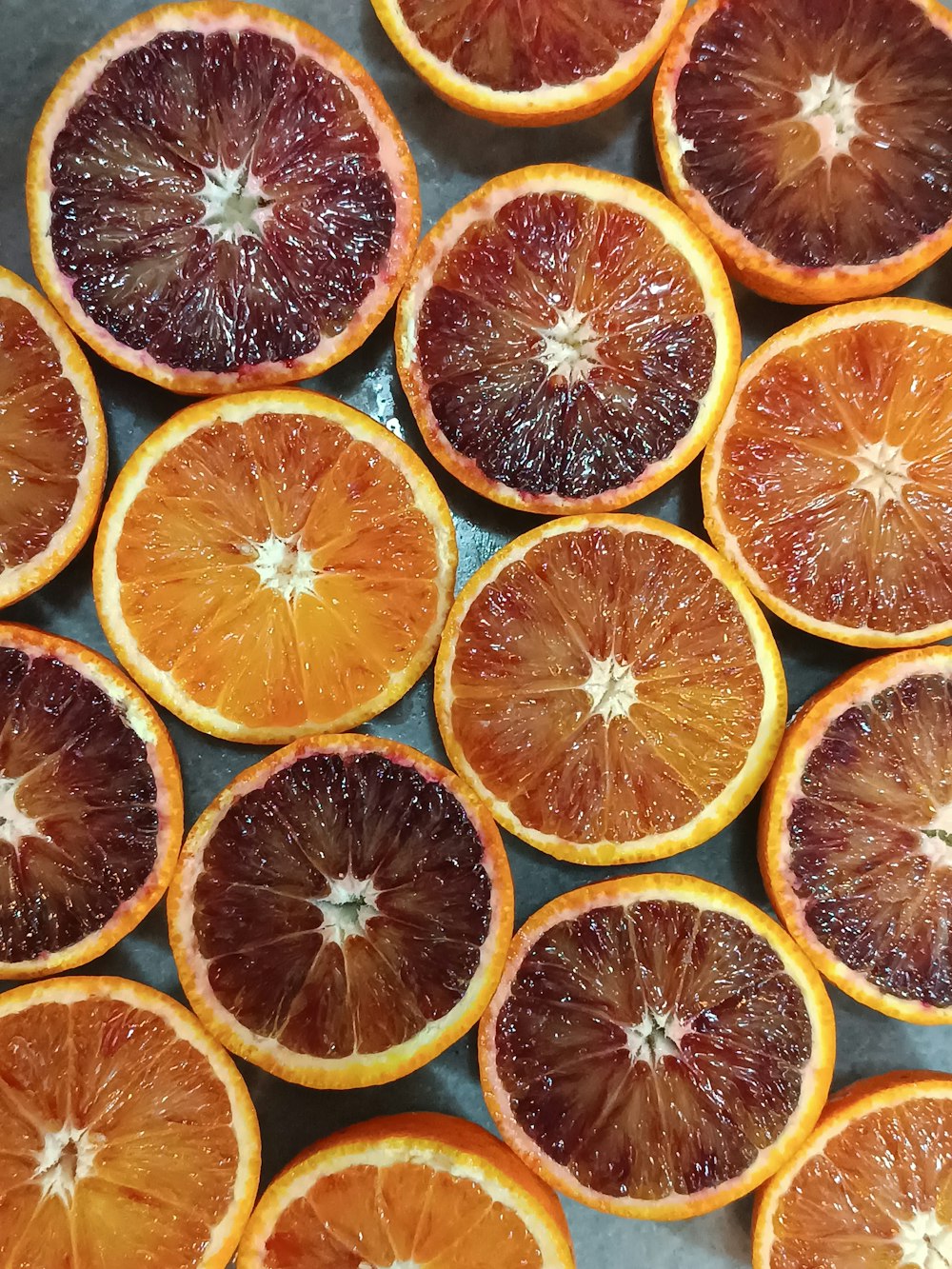 a bunch of blood oranges cut in half