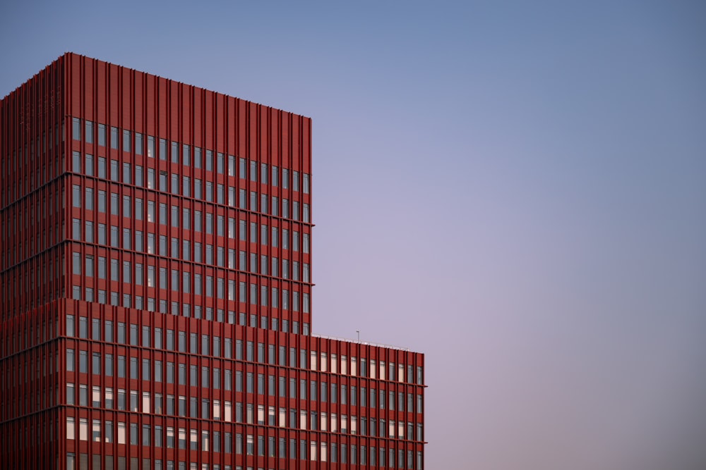 a tall red building with lots of windows