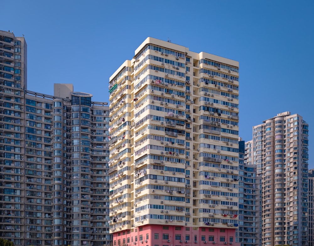 a very tall building in front of some very tall buildings