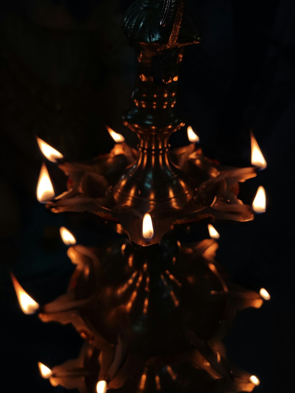 a chandelier with many lit candles inside of it