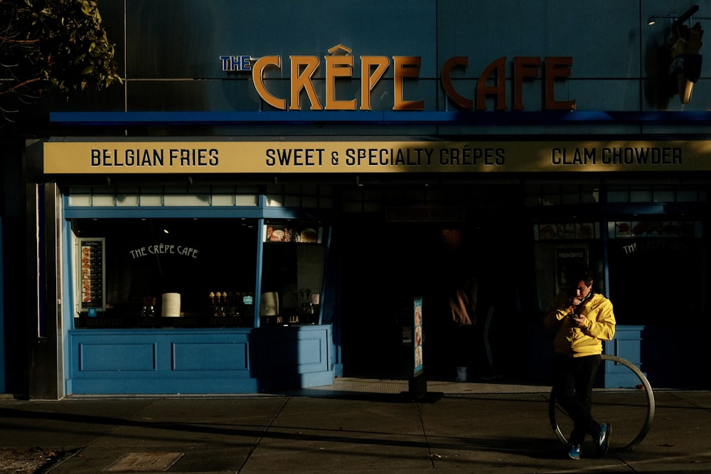 a man walking down a street next to a building