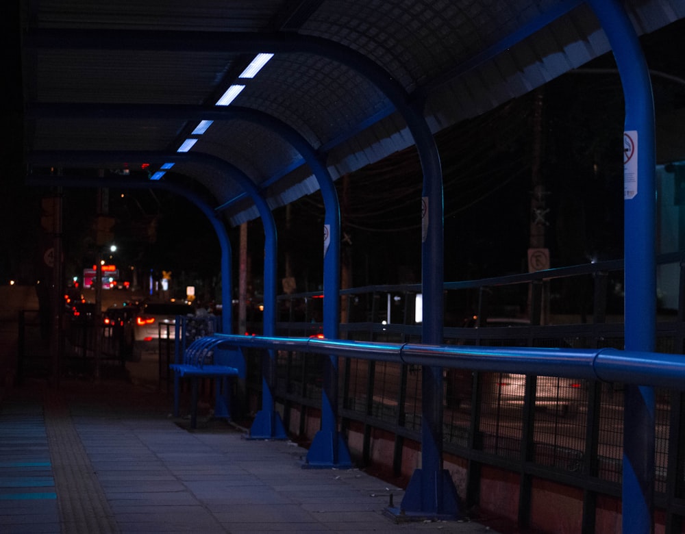 a row of blue benches sitting next to each other