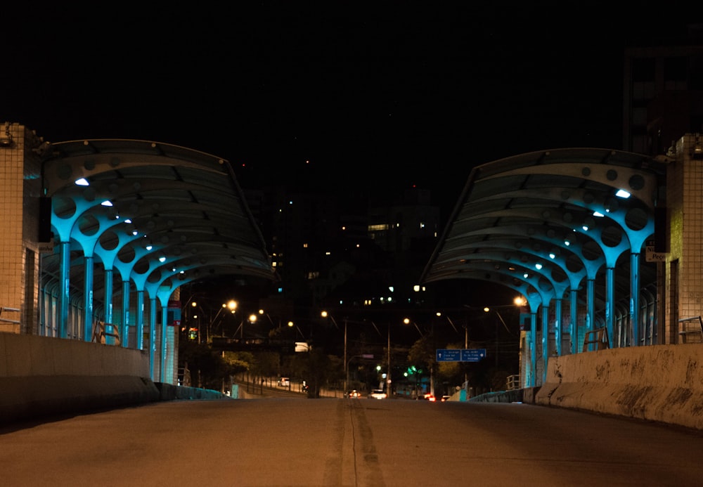 a city street at night with blue lights