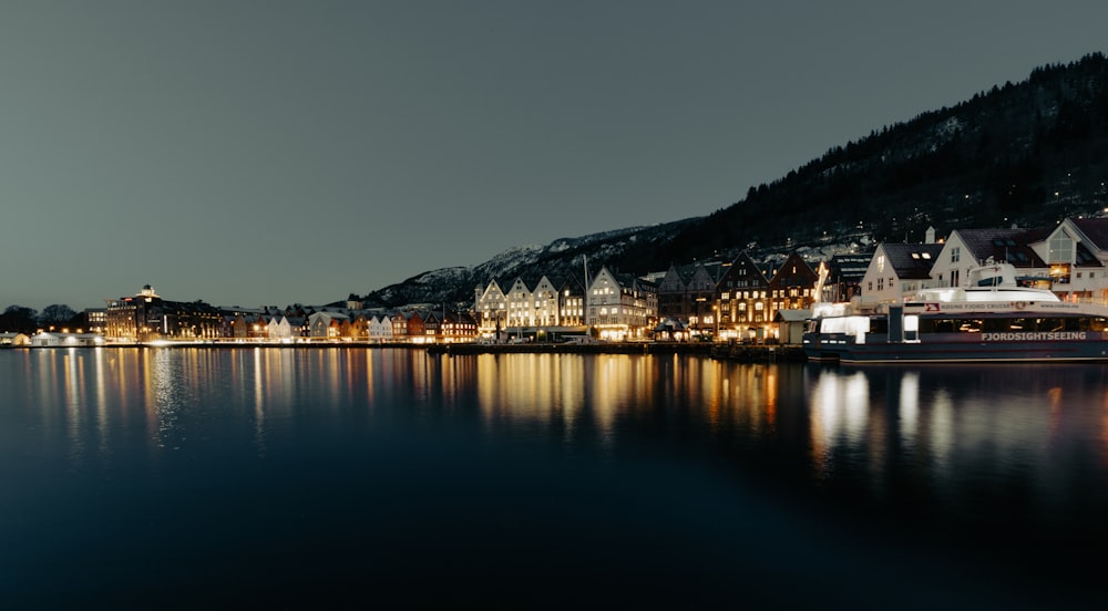 a town on the shore of a lake at night