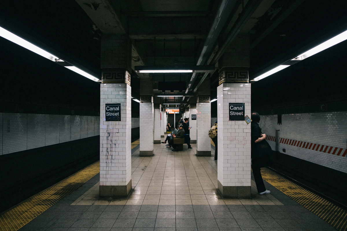 a subway station with people waiting for the train