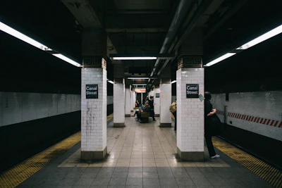 a subway station with people waiting for the train