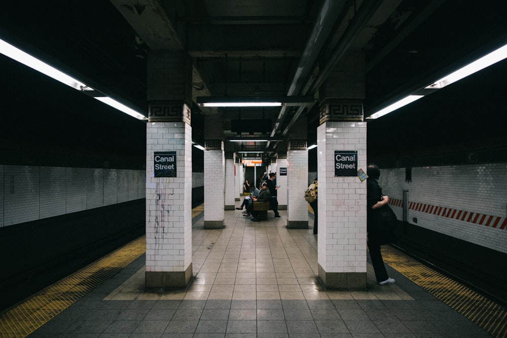 a subway station with people waiting for the train