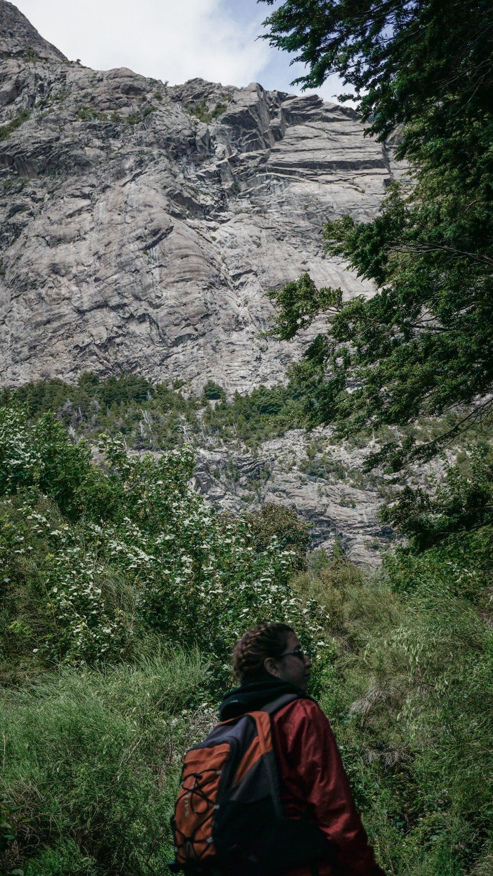 a person with a backpack walking up a hill