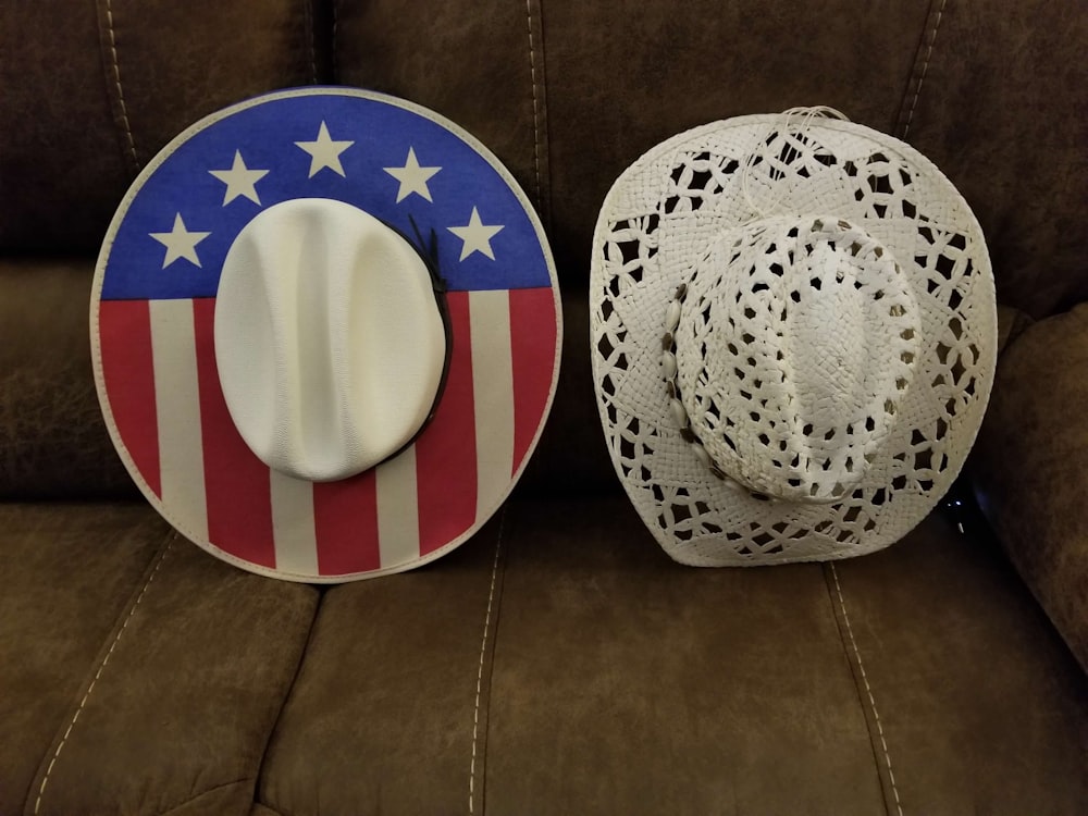 a hat and a plate sitting on a couch