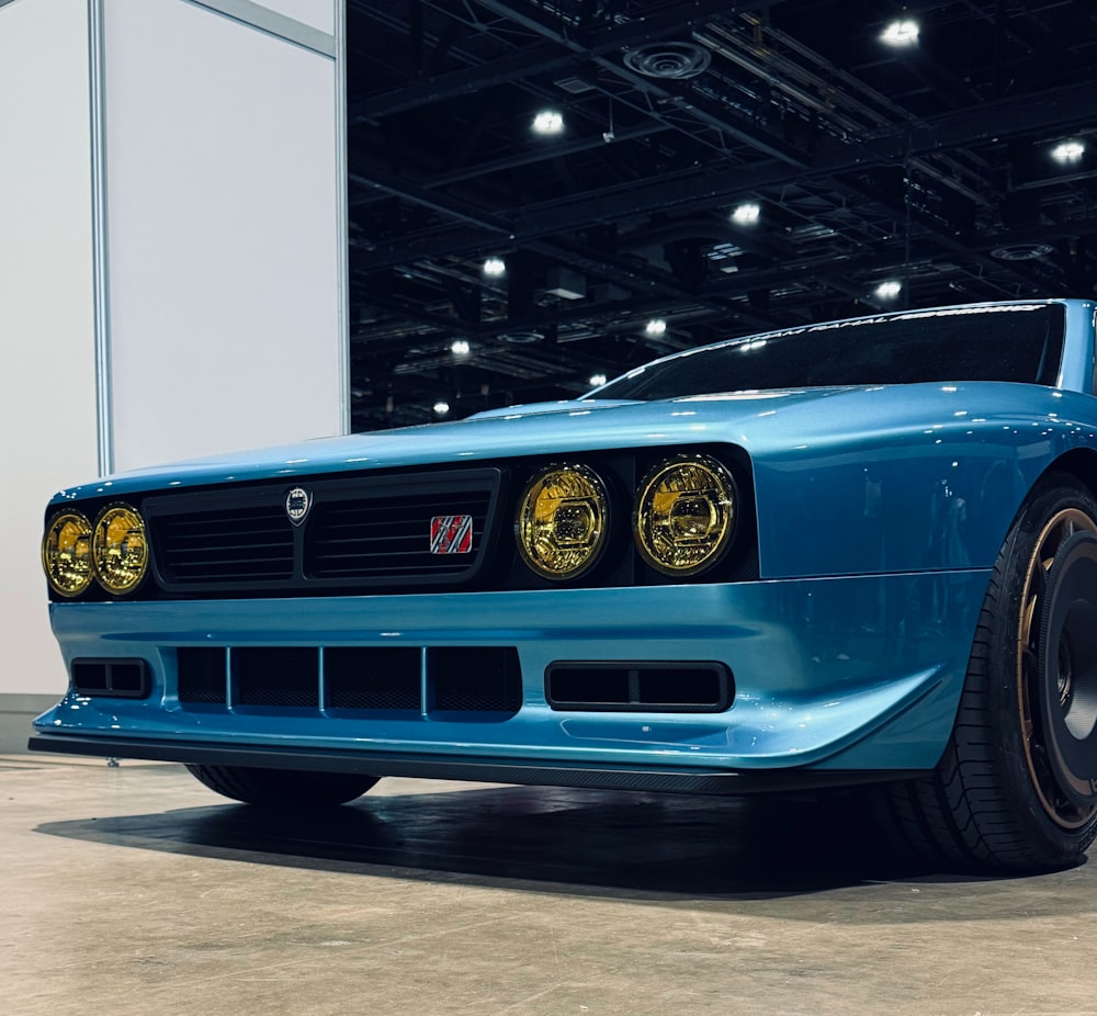 a blue sports car parked in a garage