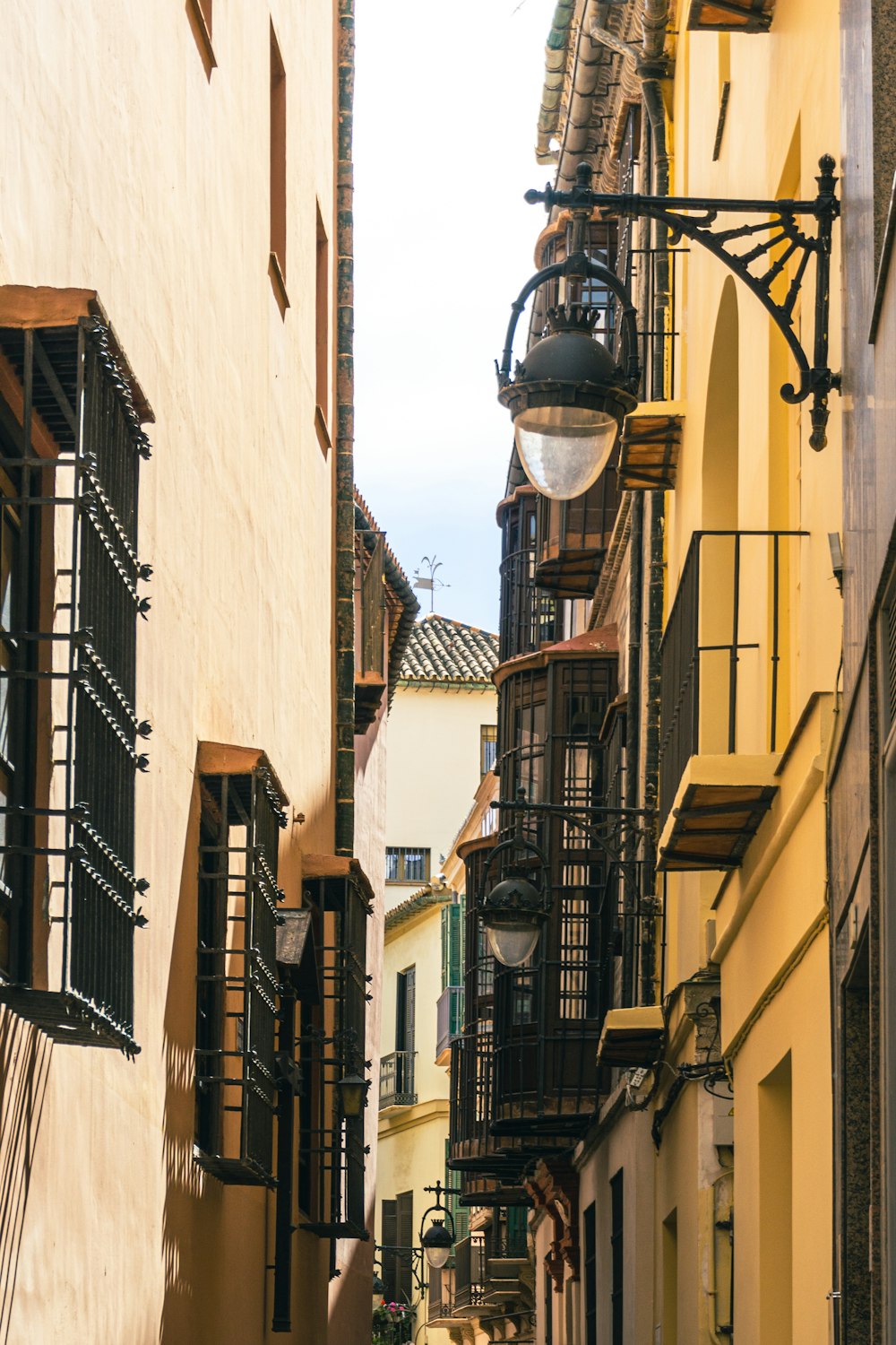 a narrow city street lined with tall buildings