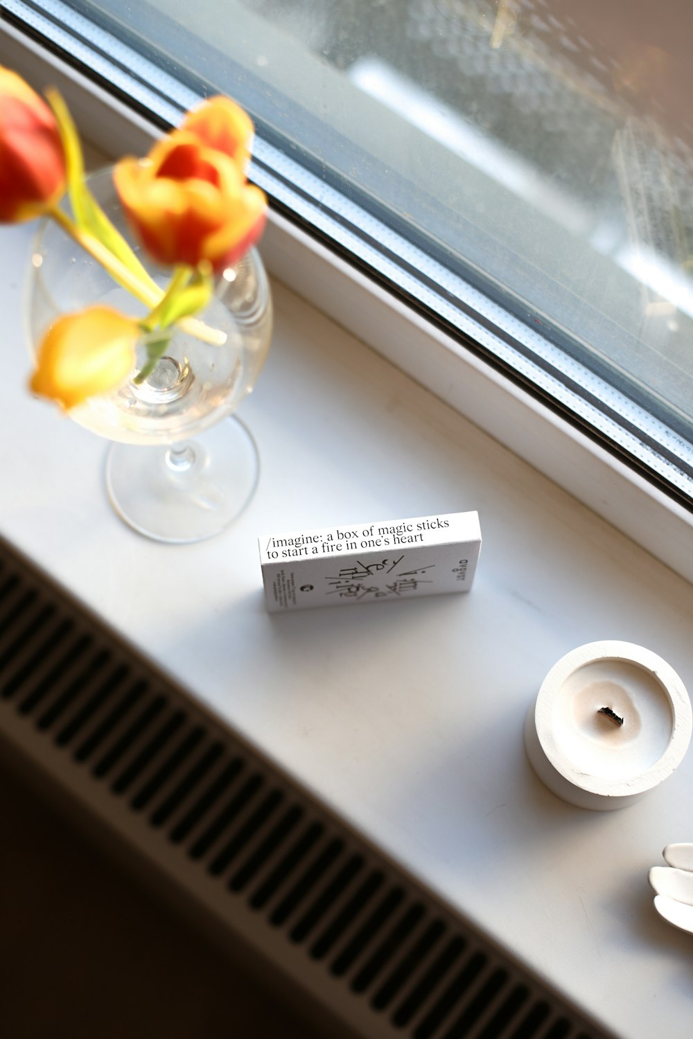 a window sill with a vase of flowers on it