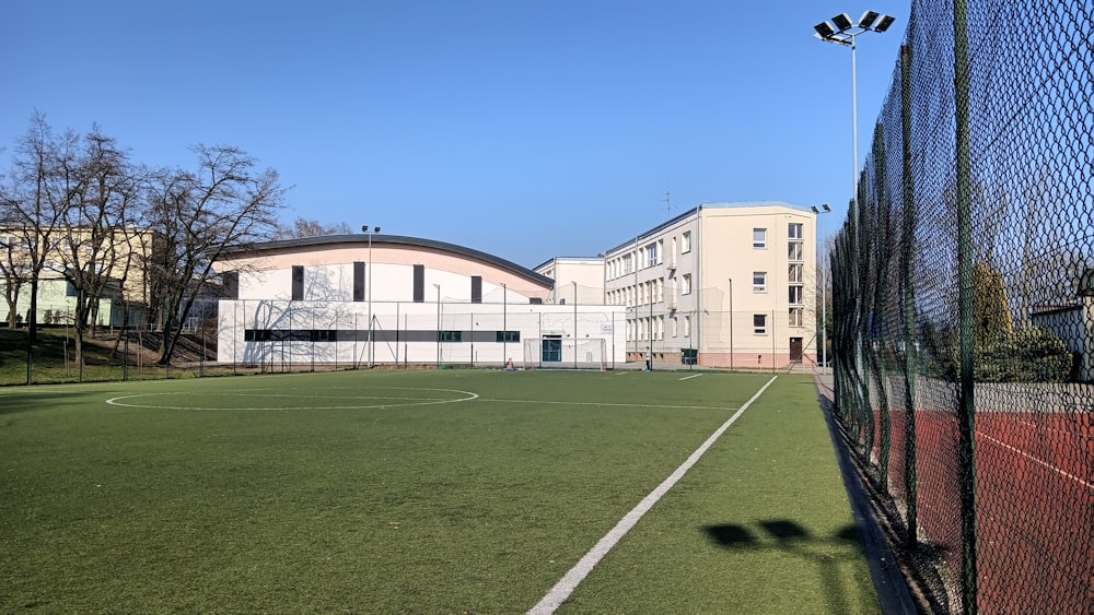 a soccer field with a building in the background