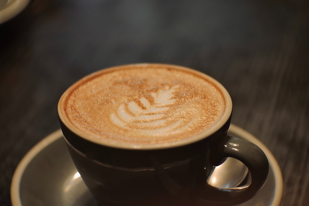 a cappuccino on a saucer on a table