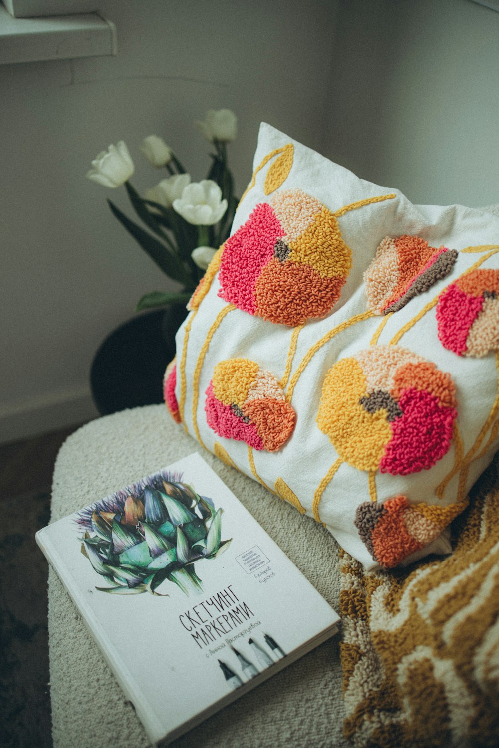 a pillow and a book on a couch