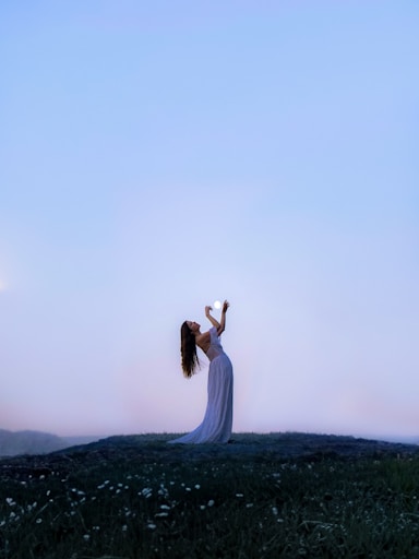 a woman standing on top of a lush green field