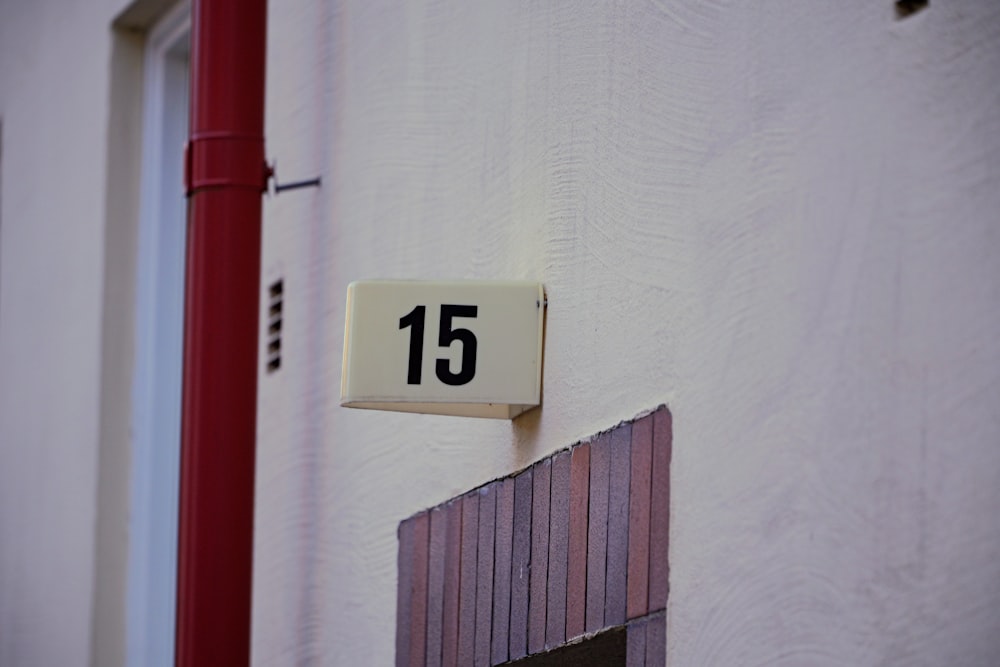 a close up of a house number on a wall