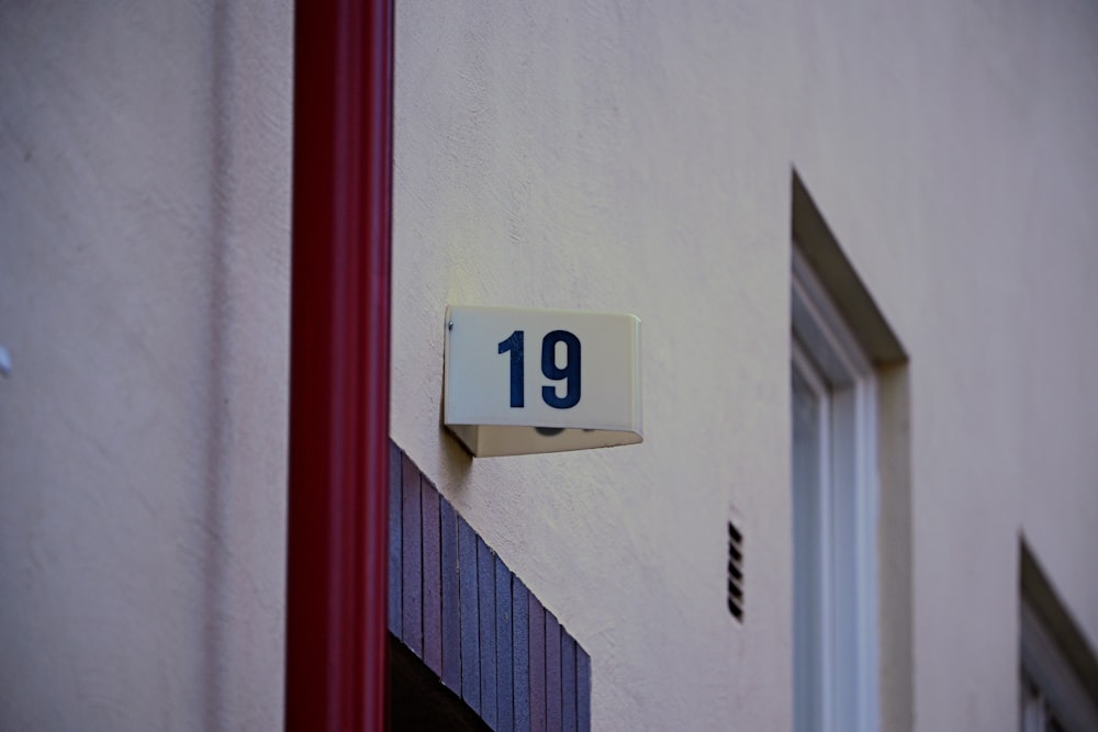 a close up of a house number sign on a building
