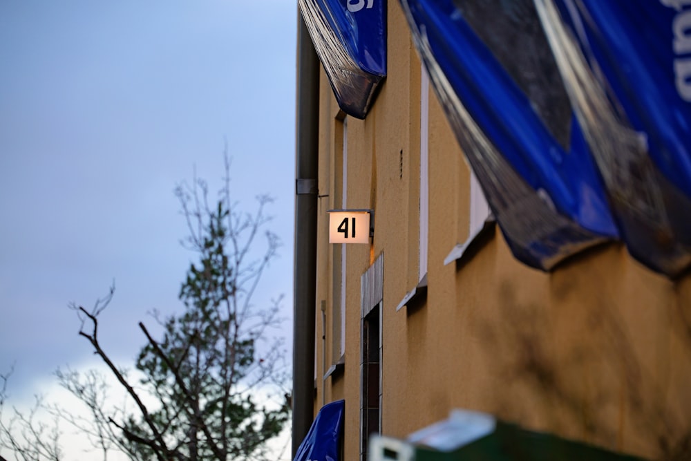 a street sign on a building with trees in the background