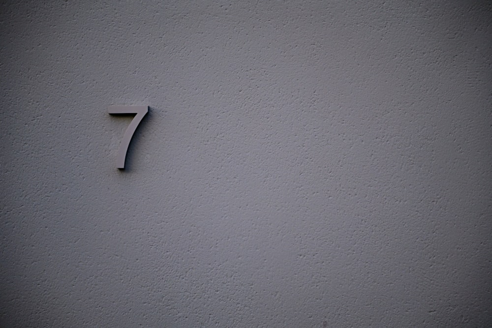 a number seven on a white wall