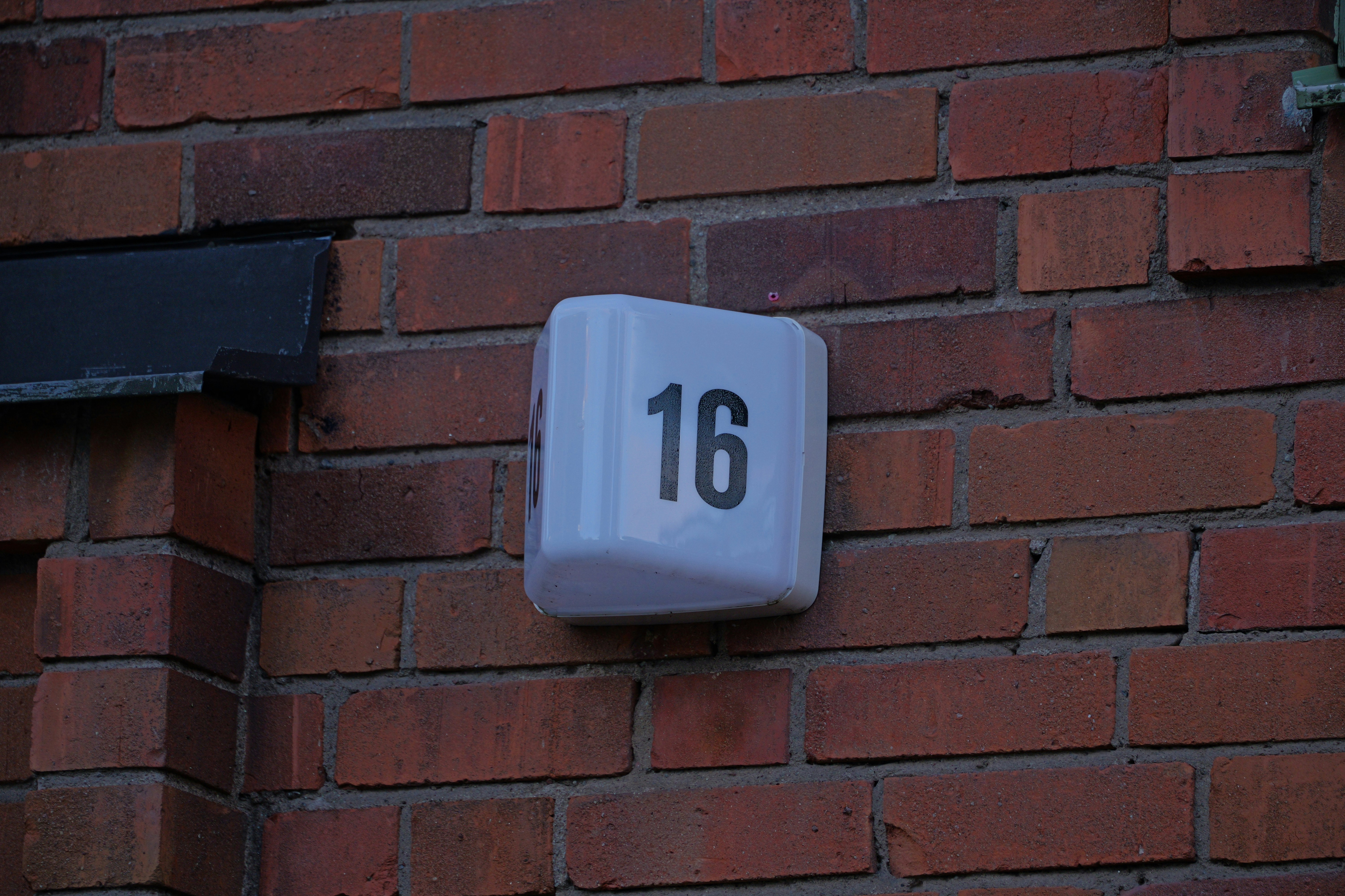 a close up of a brick wall with a clock on it