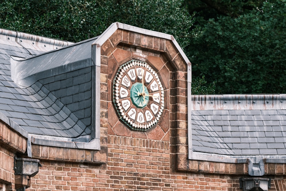 a clock on the side of a brick building