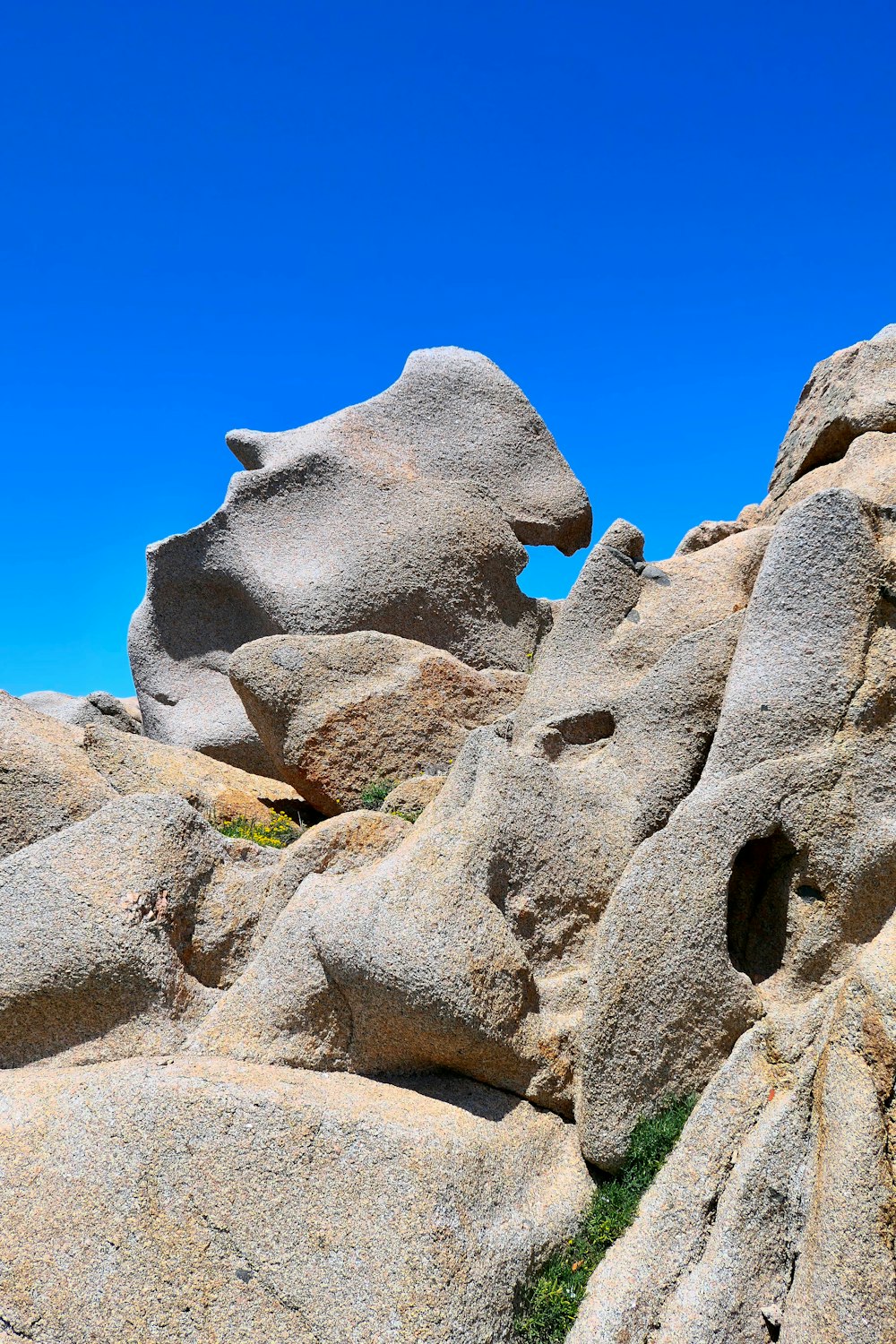 a rock formation with a blue sky in the background