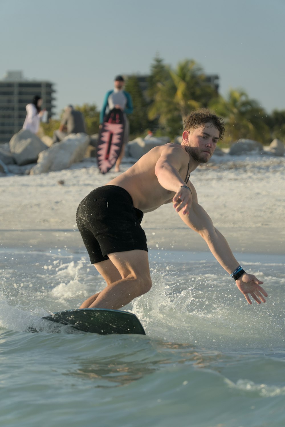 a man riding a wave on top of a surfboard