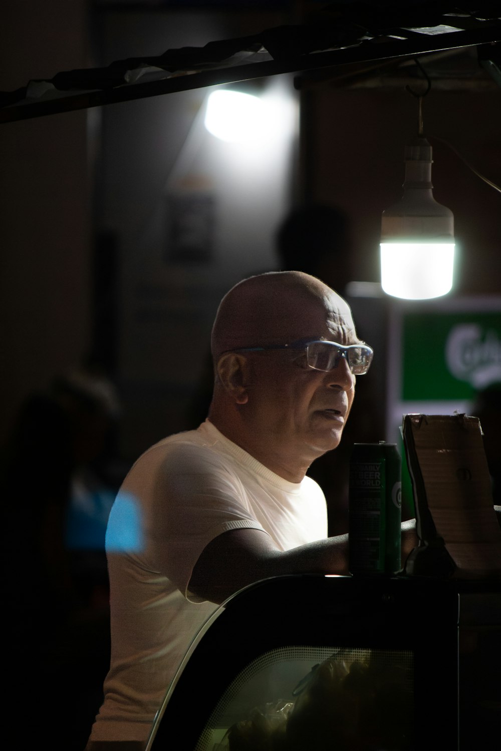 a man with glasses sitting at a table