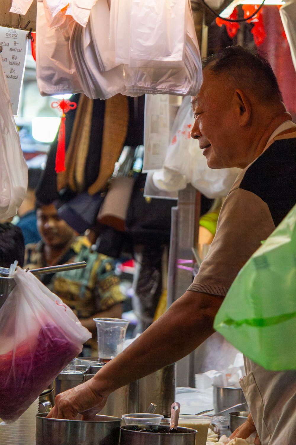 a man standing in front of a counter filled with food