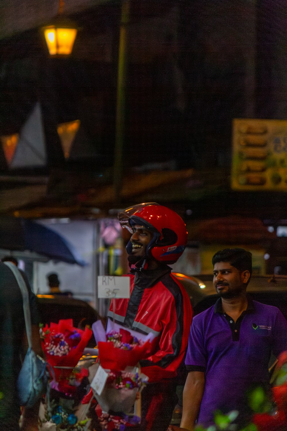 two men standing next to each other in front of a store