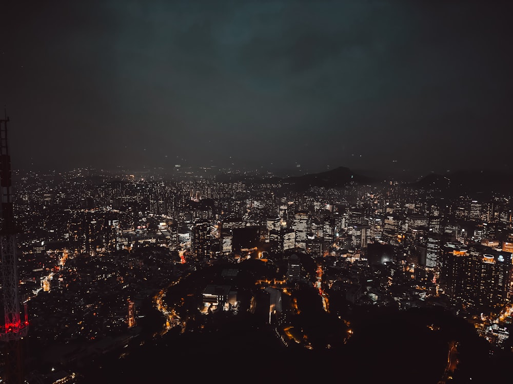 a view of a city at night from the top of a hill