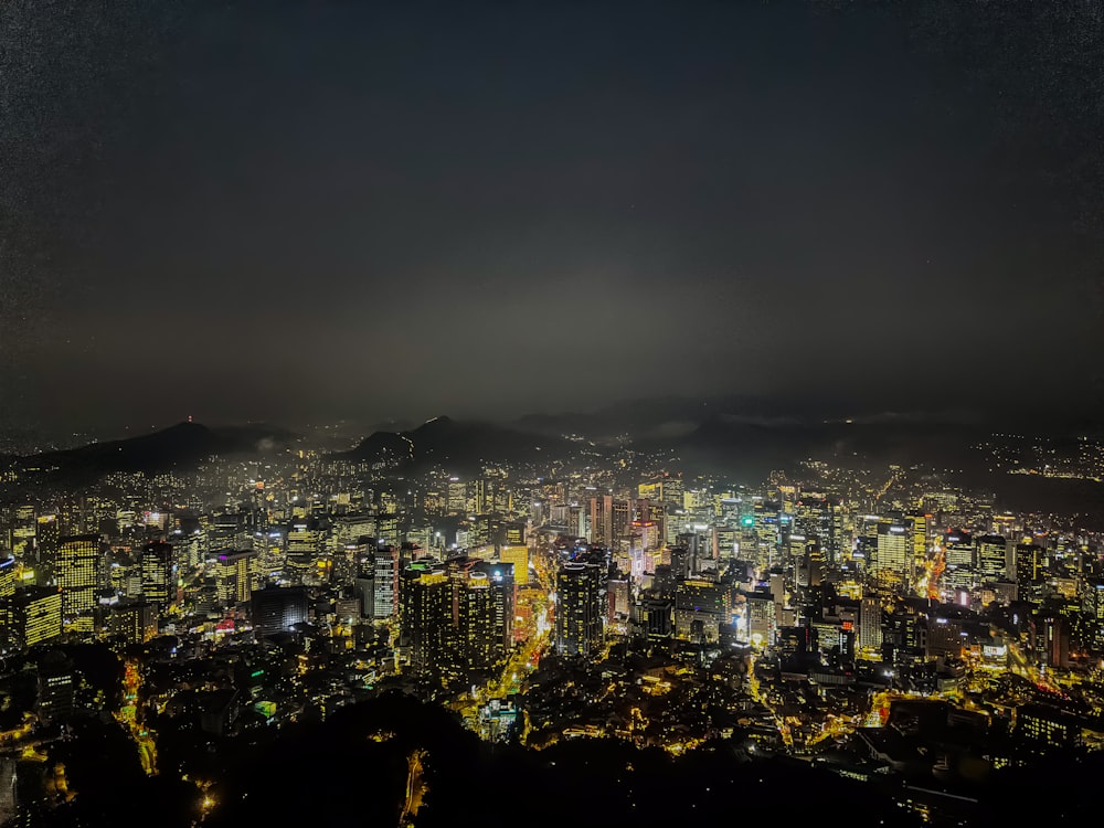 a view of a city at night from the top of a hill