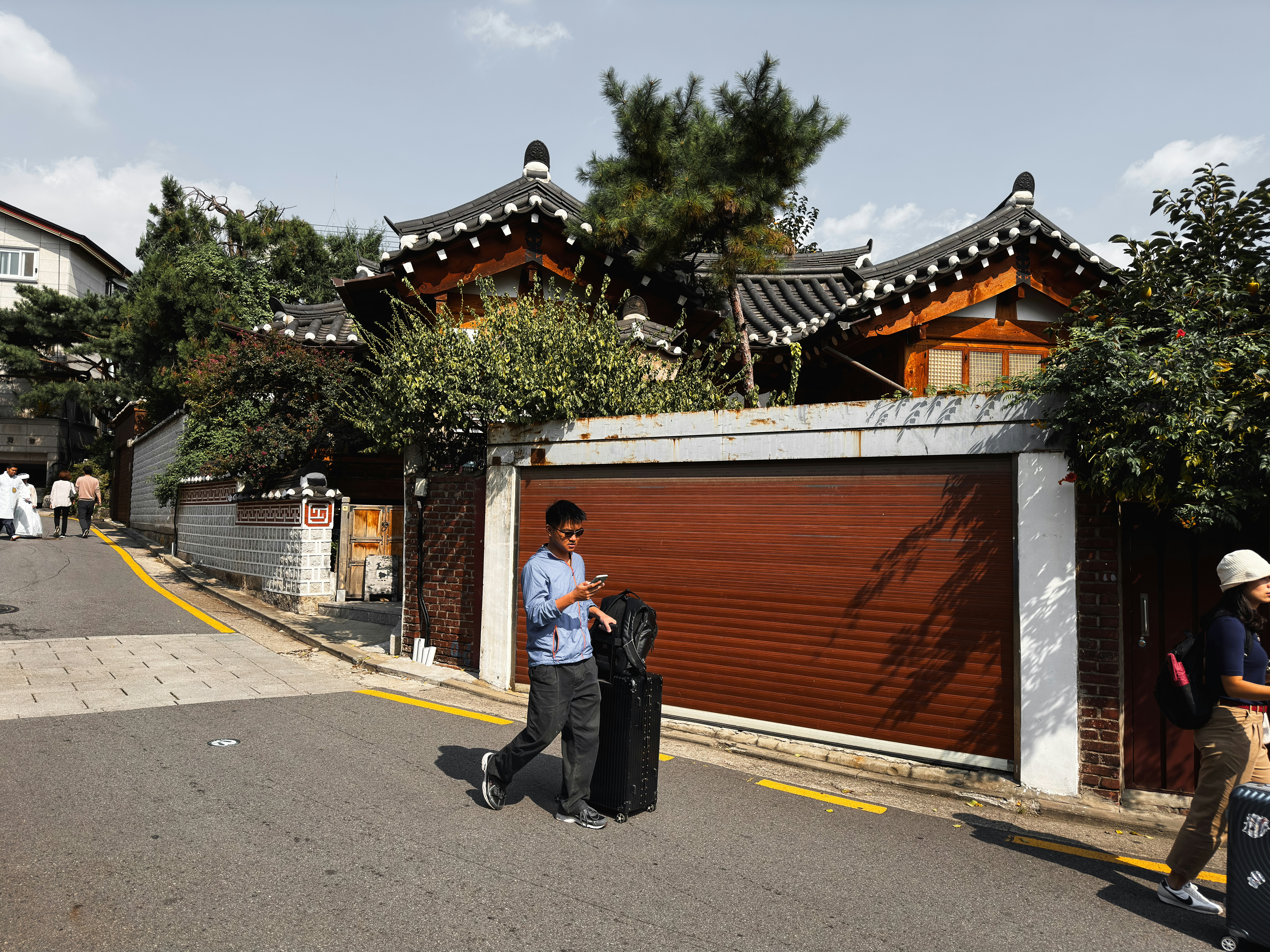 a man standing on the side of a road next to a garage