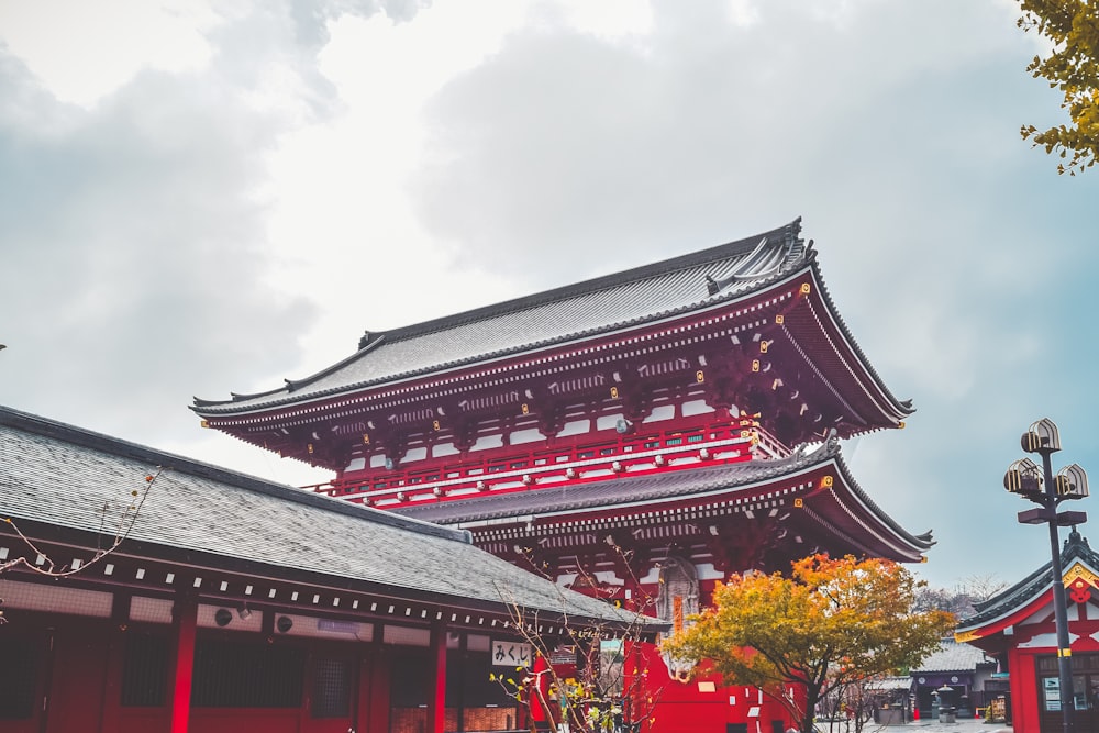 a tall red building sitting next to a tall tower