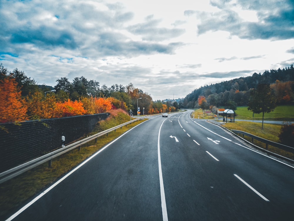 a road with a few cars driving down it