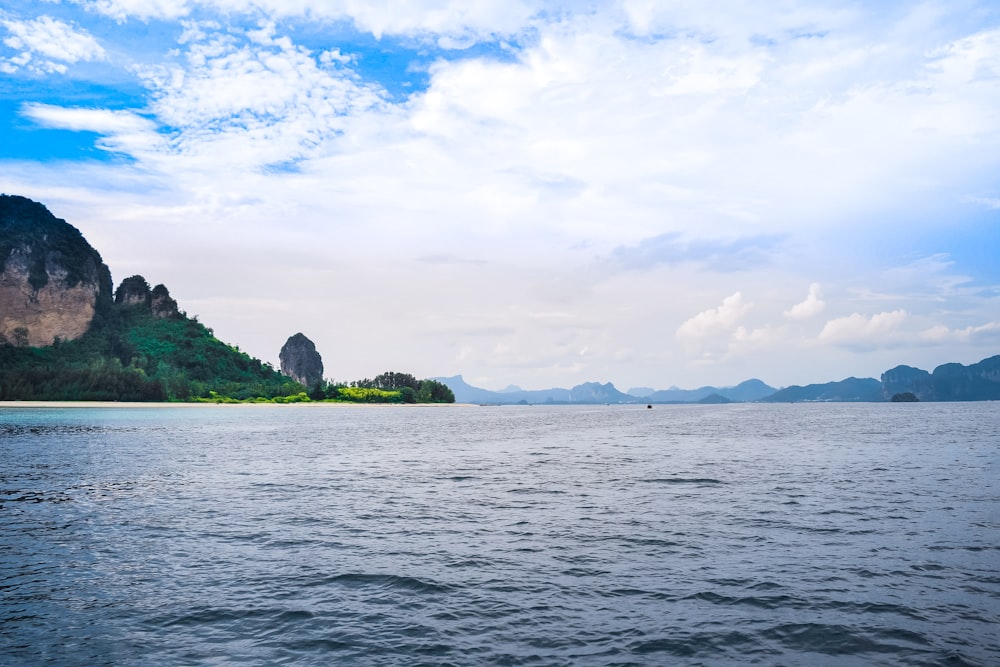 a body of water with mountains in the background