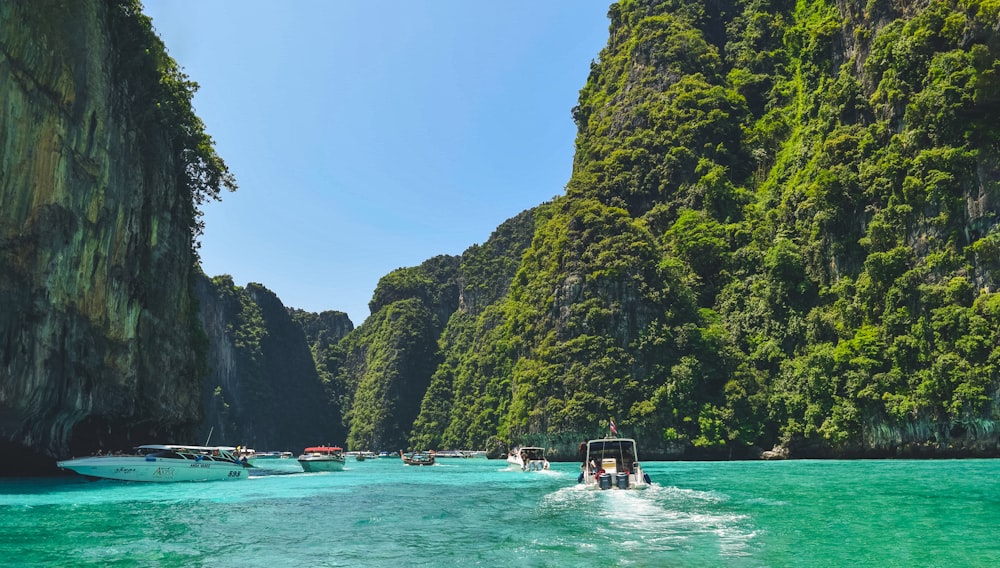 a group of boats floating on top of a body of water