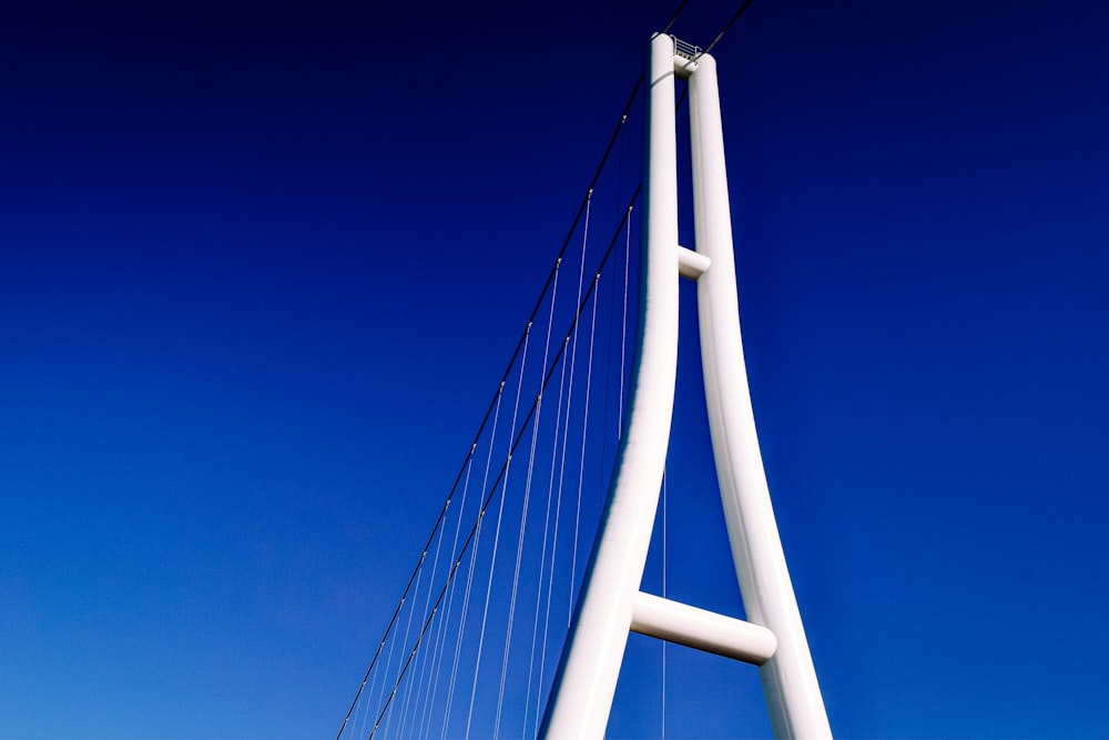 a tall white bridge with a blue sky in the background