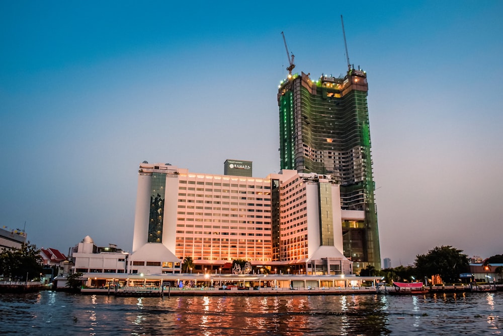 a very tall building next to a body of water