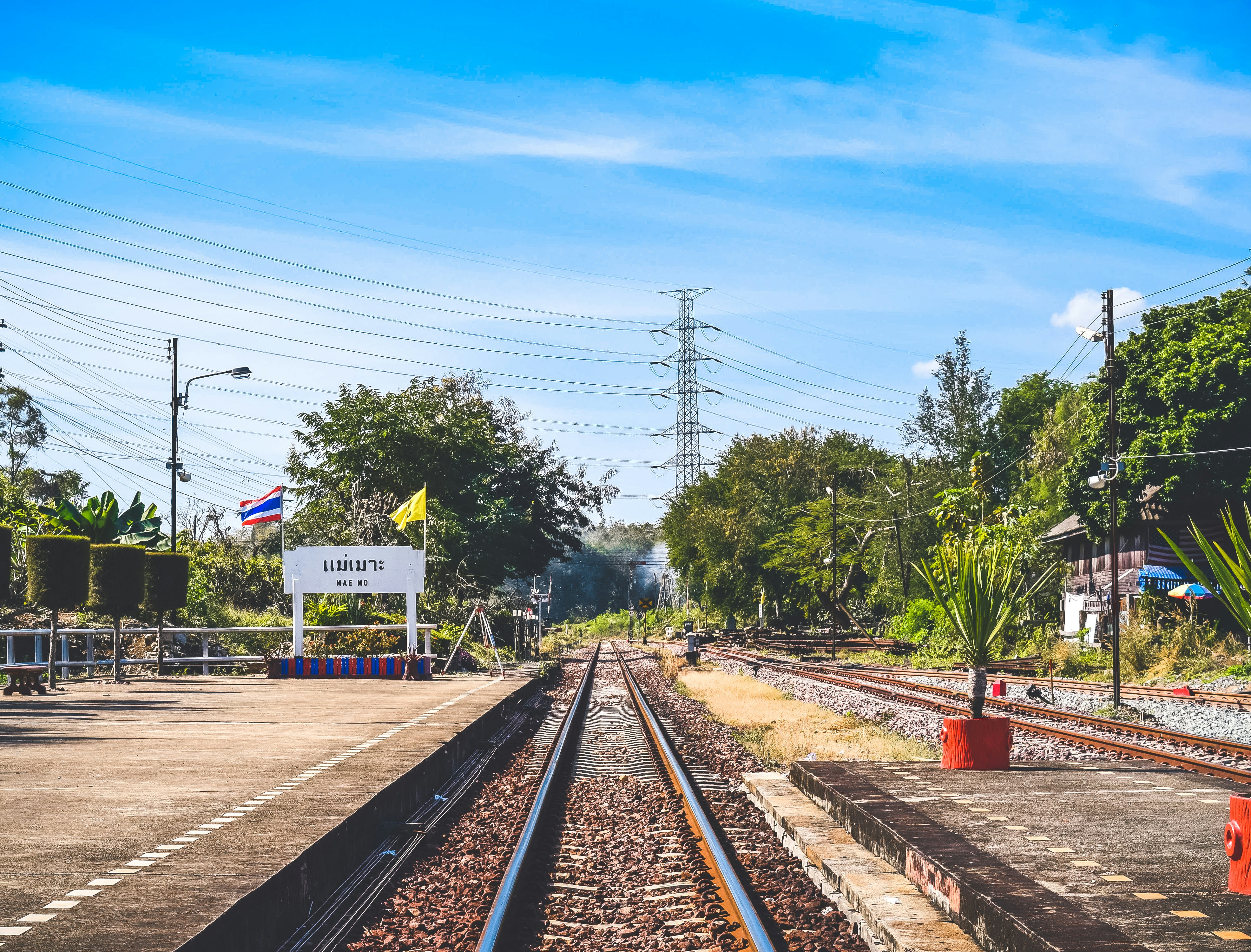 a train track with a sign on the side of it