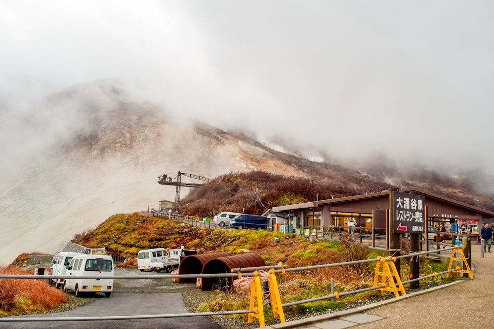 a group of trucks parked in front of a mountain