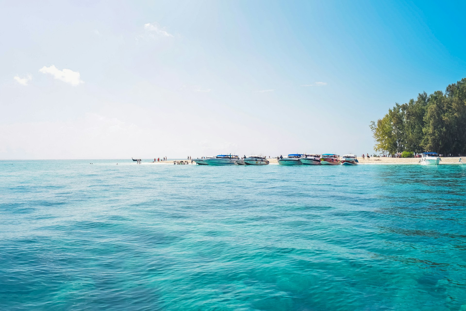 a group of boats floating on top of a body of water