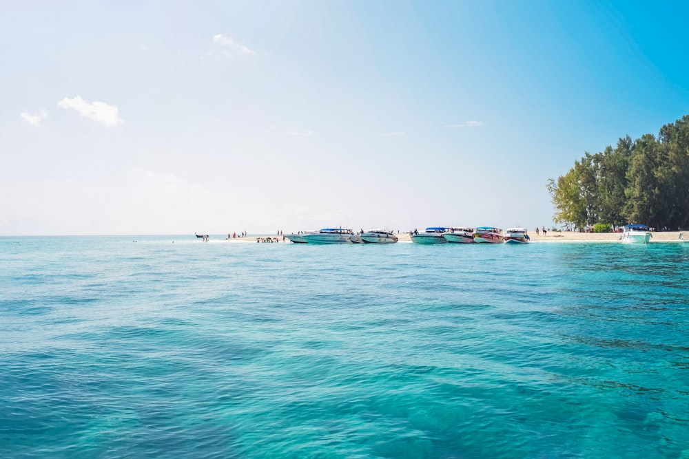 a group of boats floating on top of a body of water